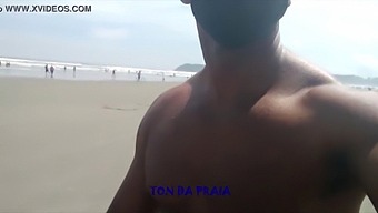 A Lot Of People On The Beach During Their Daily Stroll